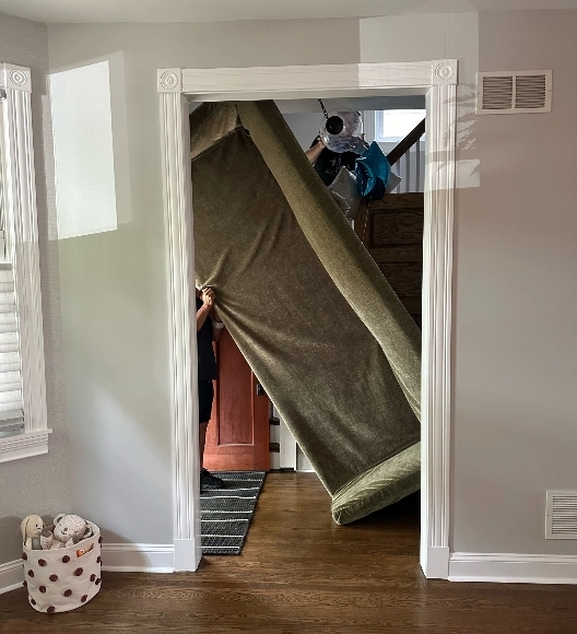 carrying sofa through a spiral staircase